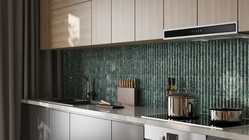 Modern kitchen backsplash featuring fluted Verde Alpi marble with a honed finish, showcasing rich green tones and natural texture.